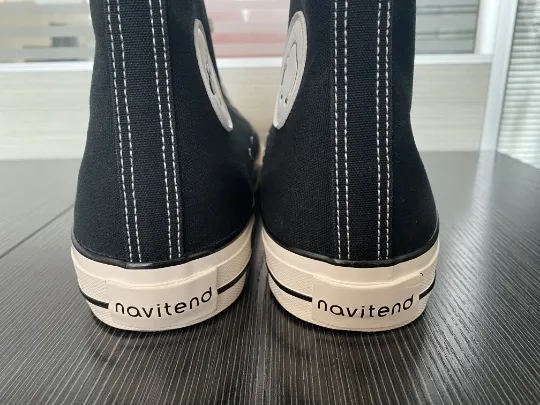 The heels of the sneakers, labeled navitend