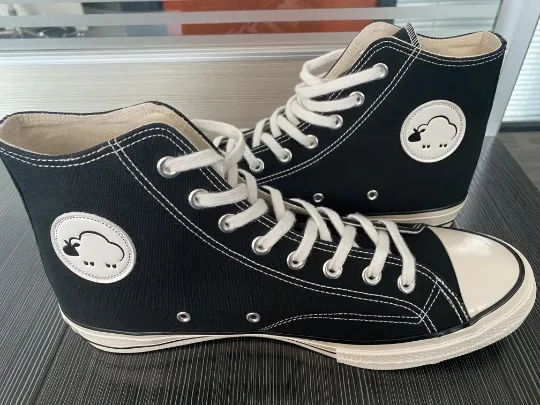 Black high-top sneakers with the Shermie logo on the side